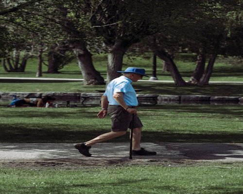 Man taking a short walking break in a local park