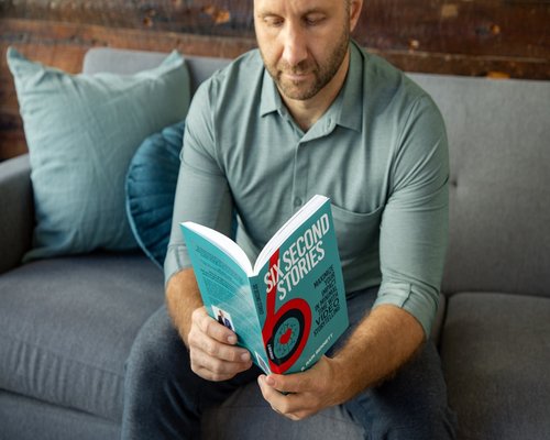 Man reading a physical book to disconnect